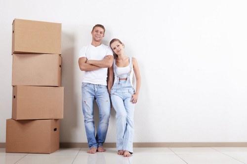 Removal team planning a flat move in Queens Park with boxes and furniture