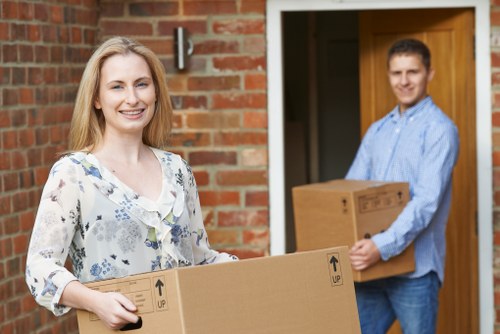 Packed moving boxes and furniture wrapped for house removals in Queens Park