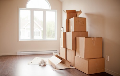 Packed office boxes and labelled files ready for relocation in Queens Park