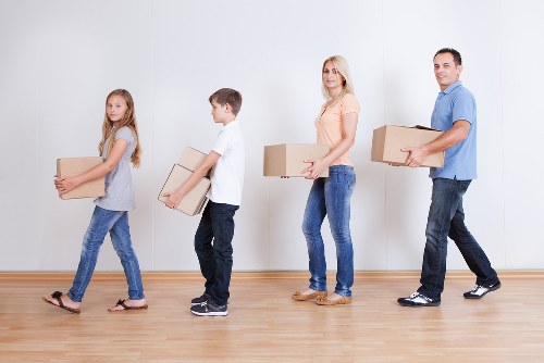 Mover carrying boxes for a Queens Park home relocation